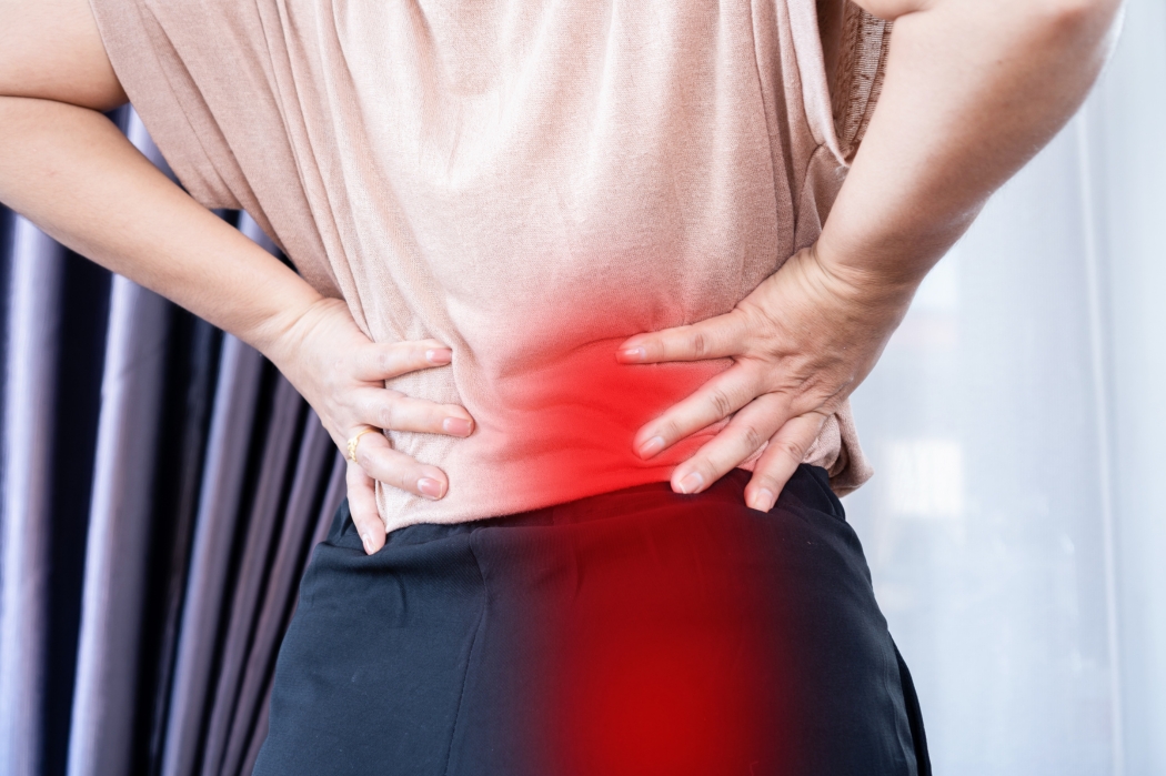 A woman suffers with sciatica pain